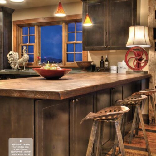 Reclaimed beams were milled into a wood-plank countertop. Tractor seats were found at a yard sale and new metal legs were created.
